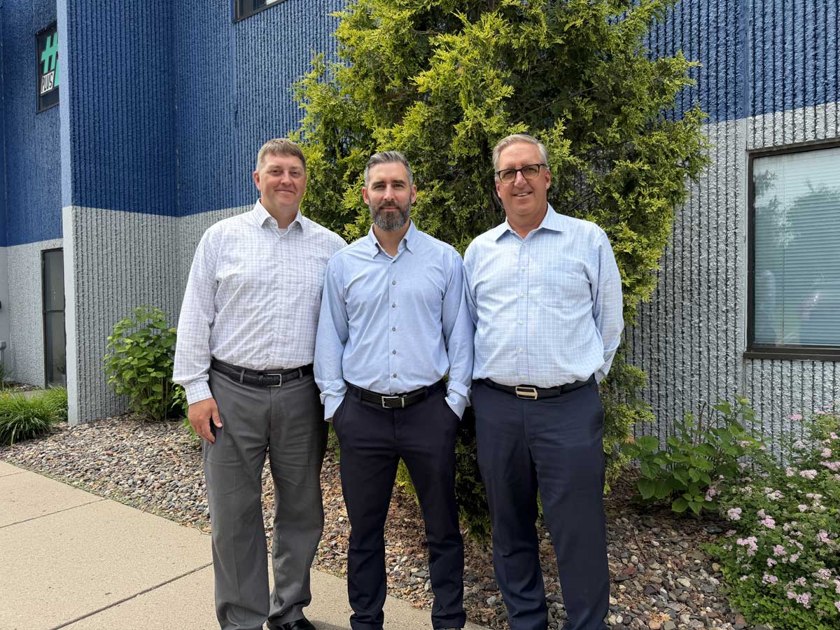Three men standing outside office building