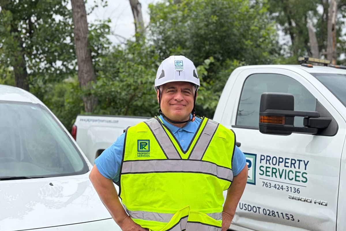 Pk Property Services Working In High Visibility Vest And Hard Hat By Branding Truck