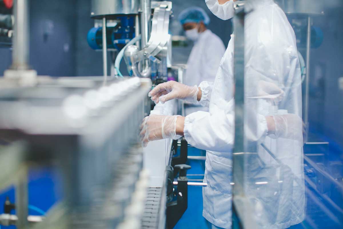 Worker In A Clean Room Assembling Medical Products